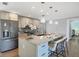 Bright kitchen featuring granite counters, stainless steel refrigerator and modern pendant lighting at 142 Sunaire Ter, Nokomis, FL 34275