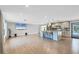 Open-concept living room features hardwood floors and adjoins a kitchen island with barstool seating at 142 Sunaire Ter, Nokomis, FL 34275