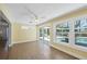 Light-filled sunroom with access to pool area through sliding glass doors, with tile flooring at 142 Sunaire Ter, Nokomis, FL 34275