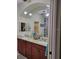 Elegant bathroom showcases a dual vanity with granite countertops and custom mirrors above dark wood cabinetry at 142 Yellow Pine Dr, Rotonda West, FL 33947