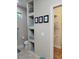 Well-organized bathroom offers a toilet, built-in shelving, and a glimpse into the walk-in closet for easy access at 142 Yellow Pine Dr, Rotonda West, FL 33947