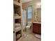 Clean and bright bathroom featuring built-in shelving, a walk-in shower, and granite countertop vanity at 142 Yellow Pine Dr, Rotonda West, FL 33947