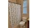 Bathroom featuring a toilet, tub, and shower with nautical themed shower curtain at 142 Yellow Pine Dr, Rotonda West, FL 33947