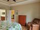 Bright bedroom with wood floors, and en-suite bathroom and walk-in closet access at 142 Yellow Pine Dr, Rotonda West, FL 33947