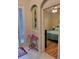 View of a bedroom featuring neutral decor, hardwood flooring, and an adjacent hallway at 142 Yellow Pine Dr, Rotonda West, FL 33947
