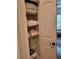 Linen closet offering ample storage with wire shelving and essentials like towels and toilet paper at 142 Yellow Pine Dr, Rotonda West, FL 33947