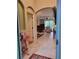 Elegant foyer view into the living room featuring tiled floors and an open floor plan at 142 Yellow Pine Dr, Rotonda West, FL 33947