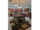 Open floor plan with full kitchen view, including stainless steel appliances and dark wood cabinetry at 142 Yellow Pine Dr, Rotonda West, FL 33947