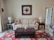 Cozy living room with neutral tones, a patterned area rug, and decorative lamps at 142 Yellow Pine Dr, Rotonda West, FL 33947