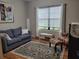 Cozy living room featuring a comfortable sofa, patterned rug, and a bright window at 142 Yellow Pine Dr, Rotonda West, FL 33947