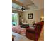 Spacious living room with coffered ceilings and views to outdoor pool area at 142 Yellow Pine Dr, Rotonda West, FL 33947
