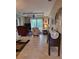 Spacious living room features a ceiling fan, sliding glass door, and an entertainment center at 142 Yellow Pine Dr, Rotonda West, FL 33947