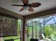 The screened lanai has outdoor seating and overhead fan, offering a comfortable space to enjoy the beautiful scenery at 142 Yellow Pine Dr, Rotonda West, FL 33947