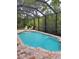 Screened-in swimming pool with brick surround and several chairs for outdoor seating at 142 Yellow Pine Dr, Rotonda West, FL 33947