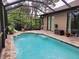The tranquil pool and patio offer an ideal space for relaxation and entertaining in a private, screened-in setting at 142 Yellow Pine Dr, Rotonda West, FL 33947