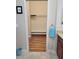 Bright walk-in closet features wooden floors, a clothing rack, and practical shelving for organized storage at 142 Yellow Pine Dr, Rotonda West, FL 33947
