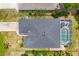 An aerial shot displays the property's roof, driveway, and screened pool area at 143 Crevalle Rd, Rotonda West, FL 33947