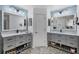 Bathroom with double vanities, marble countertops, and stylish fixtures at 143 Crevalle Rd, Rotonda West, FL 33947