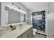 Bathroom with tiled shower, granite counters, stylish vanity, and updated fixtures at 143 Crevalle Rd, Rotonda West, FL 33947