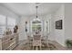 Dining area with natural light, a round table, and a stylish sideboard at 143 Crevalle Rd, Rotonda West, FL 33947