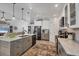 Spacious kitchen featuring an island, modern appliances, gray cabinets, and marble countertops at 143 Crevalle Rd, Rotonda West, FL 33947