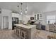 Modern kitchen features a large center island with seating and stainless steel appliances at 143 Crevalle Rd, Rotonda West, FL 33947
