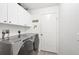 Bright laundry room with appliances, white cabinets, and a clean, functional design at 143 Crevalle Rd, Rotonda West, FL 33947