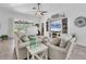 Inviting living area with neutral tones, vaulted ceiling, and a seamless flow to the outdoors at 143 Crevalle Rd, Rotonda West, FL 33947