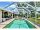 Pool and patio view of the screened-in pool with outdoor furniture and seating at 143 Crevalle Rd, Rotonda West, FL 33947