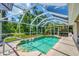 Screened-in pool surrounded by lush greenery and blue skies for outdoor enjoyment at 143 Crevalle Rd, Rotonda West, FL 33947