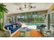 Relaxing sunroom with furniture, ceiling fans, and a view of the outdoor pool area at 143 Crevalle Rd, Rotonda West, FL 33947