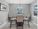 Bright breakfast nook featuring a glass table, 6 chairs, chandelier, and tile flooring at 149 Garland Way, Rotonda West, FL 33947