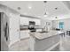 Modern kitchen featuring white cabinets, stainless steel appliances, granite countertops and a center island at 149 Garland Way, Rotonda West, FL 33947