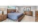 Spacious main bedroom with tile floors, dresser, ceiling fan, and screened window view at 149 Garland Way, Rotonda West, FL 33947