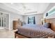 Spacious main bedroom with tray ceiling, ceiling fan, tile floors, and screened window view at 149 Garland Way, Rotonda West, FL 33947