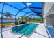 The sparkling screened-in pool has an outdoor deck area and lush landscaping at 149 Garland Way, Rotonda West, FL 33947