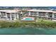 An aerial view shows a luxurious waterfront condo complex with a pool and scenic views at 1501 Beach Rd # 303, Englewood, FL 34223