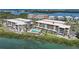 Beautiful aerial view of waterfront condos with a community pool and easy access to the bay at 1501 Beach Rd # 303, Englewood, FL 34223
