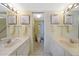 Bathroom featuring double sinks with lighted vanity mirrors and a toilet at 1501 Beach Rd # 303, Englewood, FL 34223