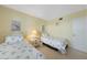 Charming bedroom featuring twin beds with coastal-themed decor and comfortable furnishings at 1501 Beach Rd # 303, Englewood, FL 34223