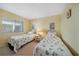 Comfortable bedroom with two twin beds, complemented by a window and cozy decor at 1501 Beach Rd # 303, Englewood, FL 34223