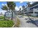 Condominium exterior showcasing lush landscaping and a welcoming entrance sign at 1501 Beach Rd # 303, Englewood, FL 34223