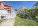 A charming condo exterior with a white picket fence and private property signs at 1501 Beach Rd # 303, Englewood, FL 34223