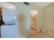 Hallway near bedroom featuring a laundry closet with stacked washer and dryer, plus entrance to bathroom at 1501 Beach Rd # 303, Englewood, FL 34223