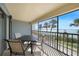 Screened lanai featuring comfortable seating and dining area with serene waterfront views at 1501 Beach Rd # 303, Englewood, FL 34223