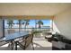 Relaxing lanai with seating area, dining table, and stunning water views at 1501 Beach Rd # 303, Englewood, FL 34223