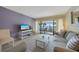 Bright and airy living room with water views from the balcony and comfortable seating at 1501 Beach Rd # 303, Englewood, FL 34223