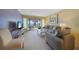 Inviting living room with a balcony overlooking the water, and comfortable furnishings at 1501 Beach Rd # 303, Englewood, FL 34223