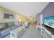Cozy living room with serene beachy decor, open to dining area, and lots of light at 1501 Beach Rd # 303, Englewood, FL 34223
