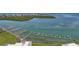 This aerial shot showcases a marina with boat lifts, perfect for the avid boater at 1501 Beach Rd # 303, Englewood, FL 34223